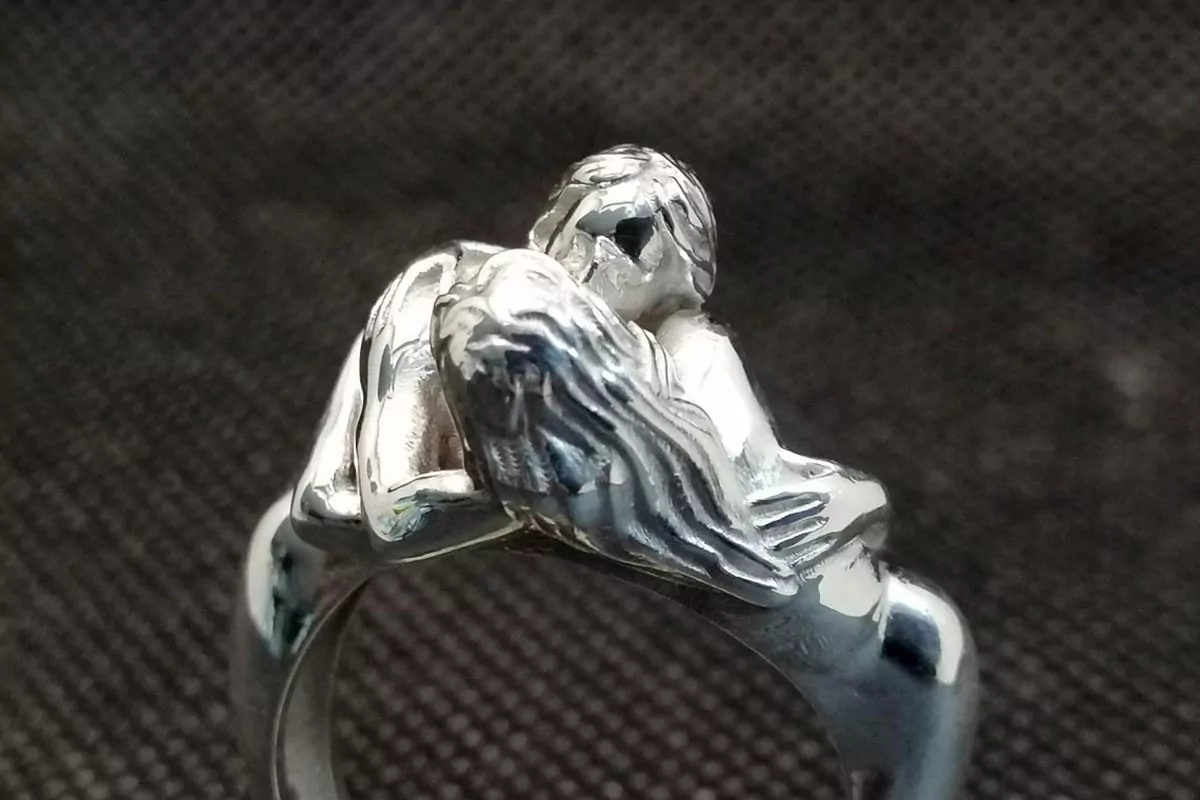 Nude women couple kissing ring